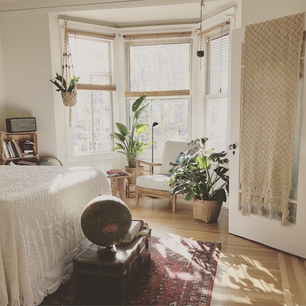 plusieurs-plantes-macramé-dans-une-chambre-ethnique-cosy-aux-meubles-anciens kilim, macramé mural, couverture de lit tressée, plantes vertes en pot, décoration bohème ethnique